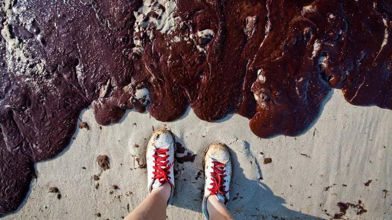 Photographer on the beach at Bon Secour National Wildlife Refuge in Alabama gets up close to BP oil that washed up on the beach.