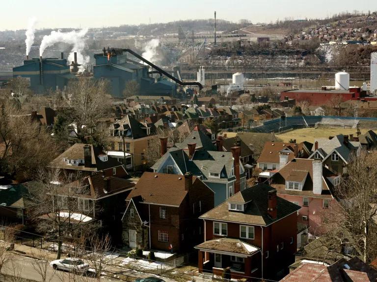 The U.S. Steel Edgar Thomson plant can be seen emitting smoke in the distance.