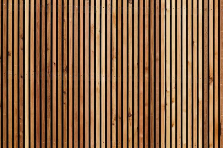 A wall of evenly spaced vertical wood cuts