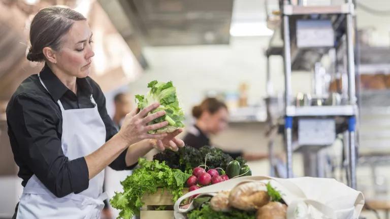 A chef preparing produce in a restaurant kitchen in Portland, Oregon.