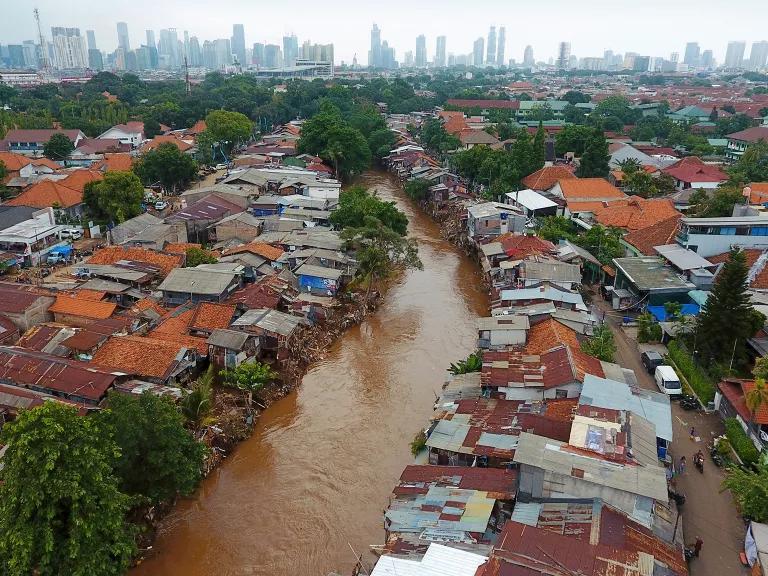 An aerial view of homes near brown waterways