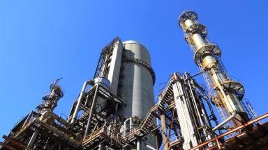 Low-angle shot of manufacturing plant under blue sky