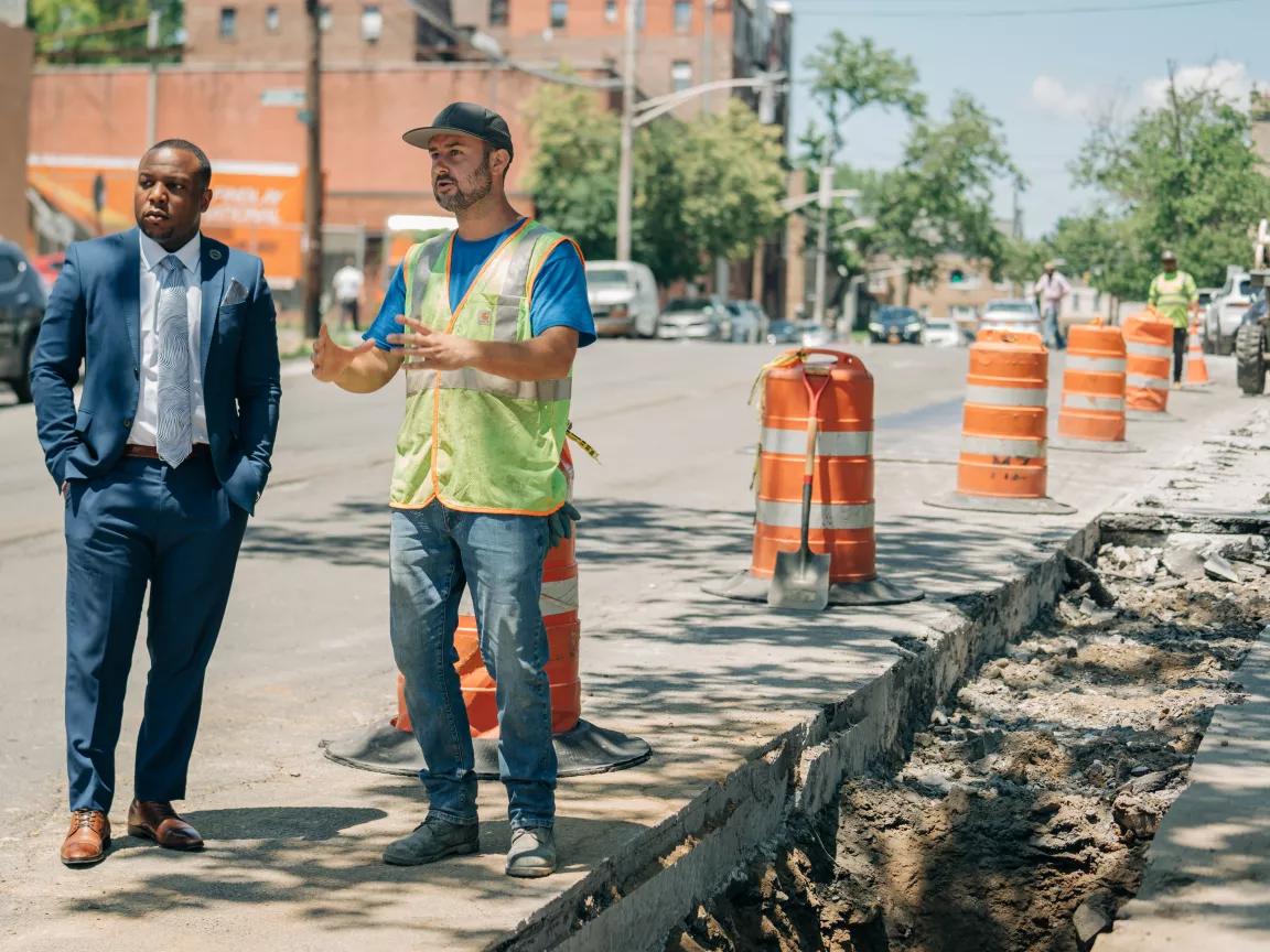 Mount Vernon's public works commissioner, Damani Bush, listens to Sam Teixeira talk about maintenance on a sewer line in Mount Vernon, New York, on June 15, 2022