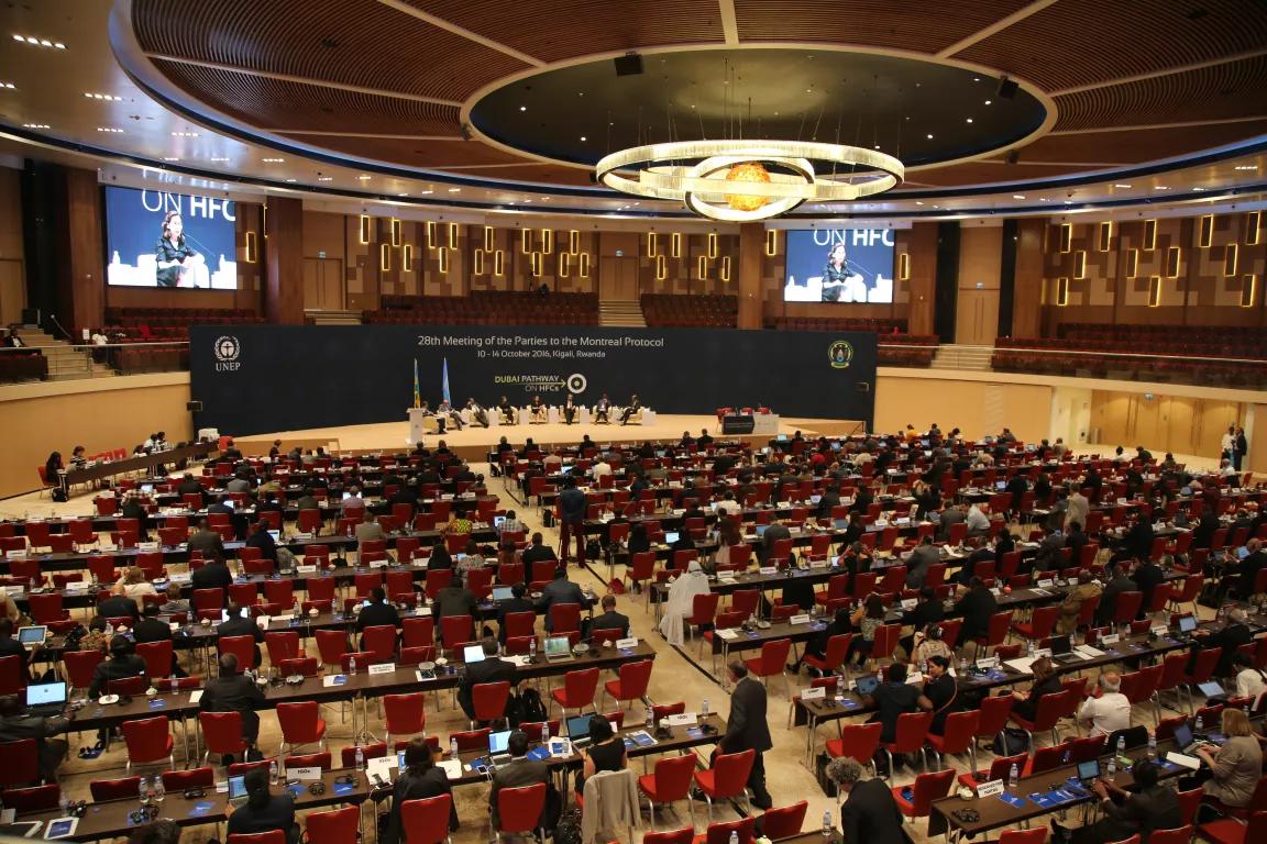 A view looking onto the stage at the 28th meeting of the Parties to the Montreal Protocol in Kigali, Rwanda, in 2016, with delegate seated in the audience