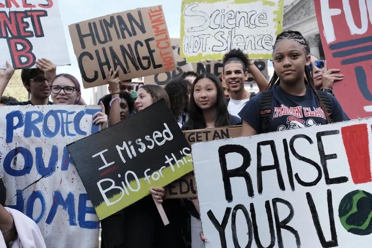 A group of young people holding protest signs