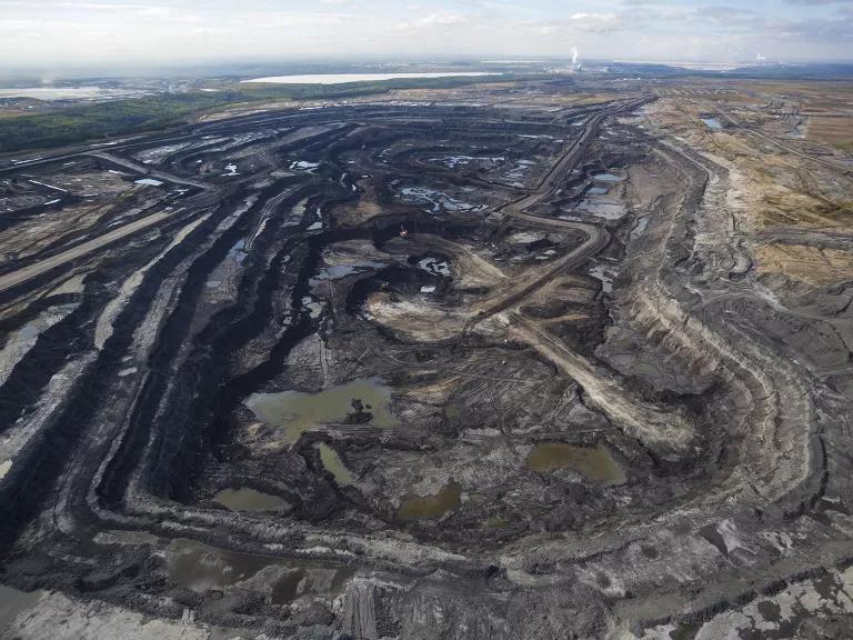 An aerial view of a vast open mine pit 